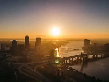 A beach scene with gentle waves washing onto the shore at sunset. The sky is a mix of soft pinks and oranges, and a person is visible in the distance near the water. A beach scene with gentle waves washing onto the shore at sunset. The sky is a mix of soft pinks and oranges, and a person is visible in the distance near the water.