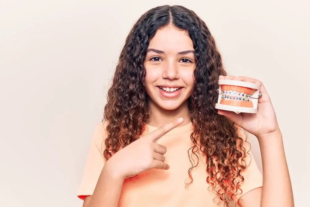 Confident young woman smiling during an orthodontic treatment journey with affordable braces cost at Bold Bite Orthodontics in Jacksonville, FL
