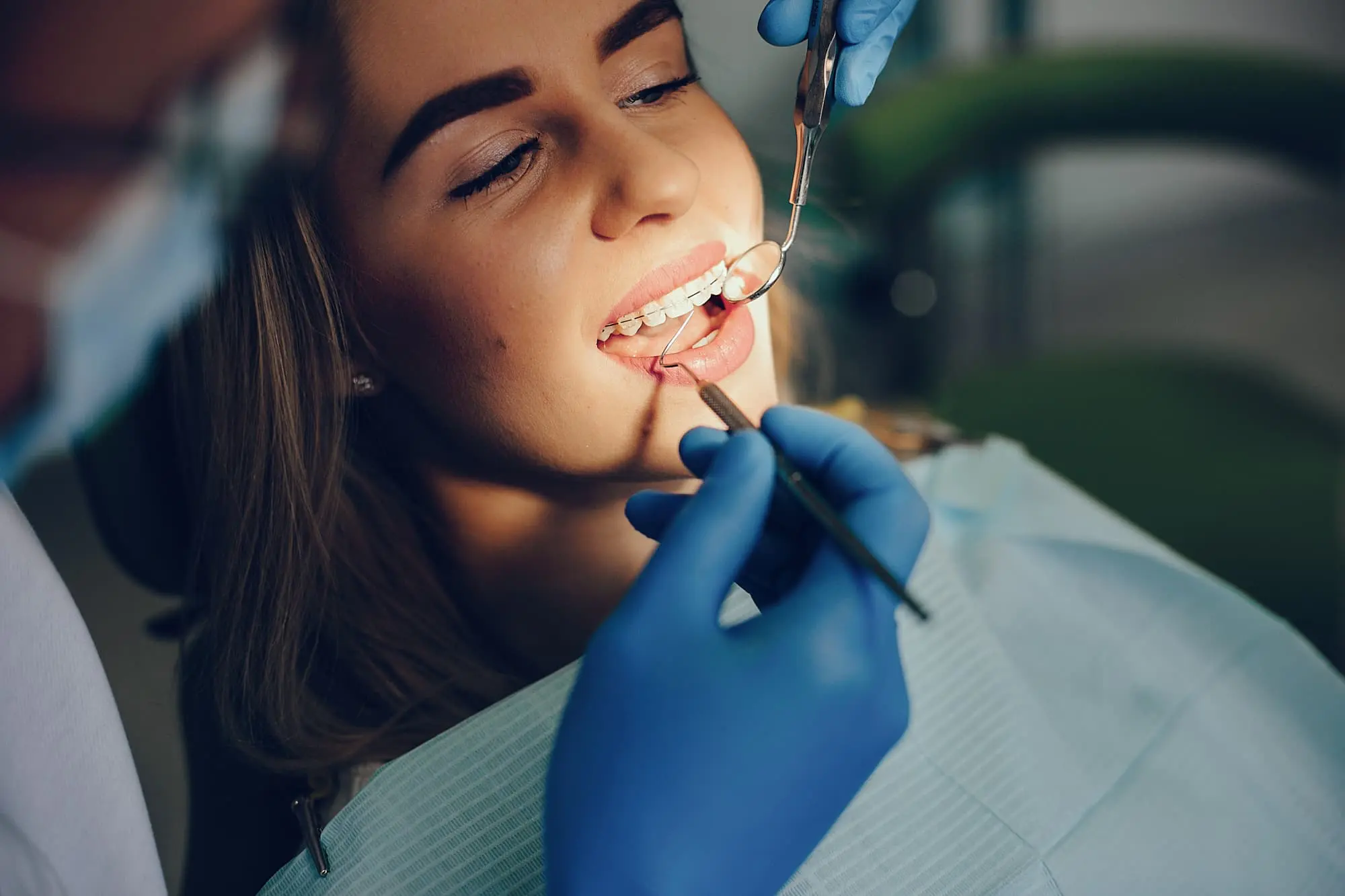 A woman at the dentist is having their teeth examined by a professional and getting affordable braces cost at Bold Bite Orthodontics in Jacksonville, FL