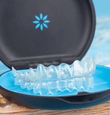 A clear dental aligner sits in an open blue and black plastic case in Jacksonville, FL. Discover flexible Invisalign payment plans to help you achieve your perfect smile with ease.