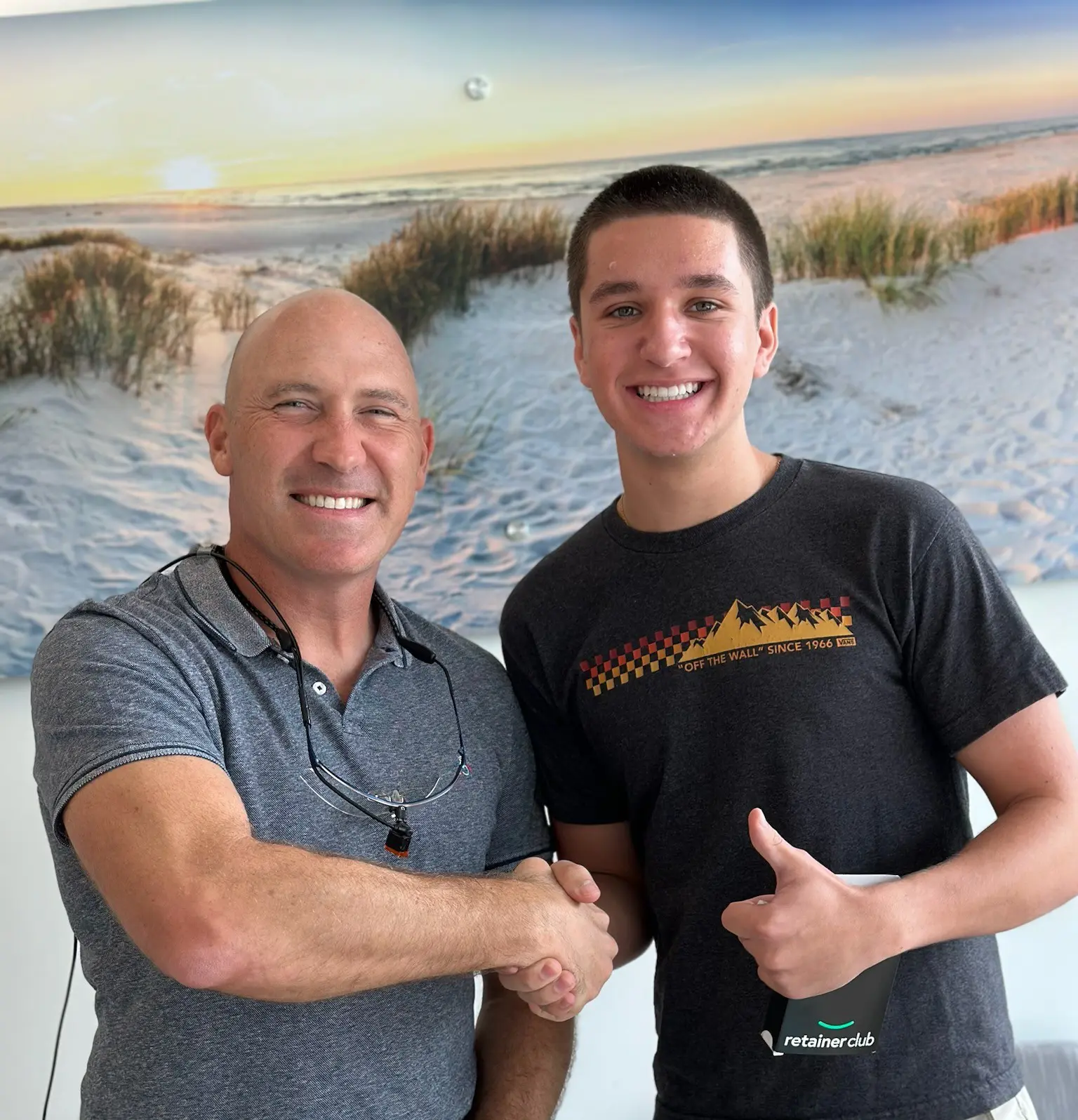 A beach scene with gentle waves washing onto the shore at sunset. The sky is a mix of soft pinks and oranges, and a person is visible in the distance near the water. A beach scene with gentle waves washing onto the shore at sunset. The sky is a mix of soft pinks and oranges, and a person is visible in the distance near the water.