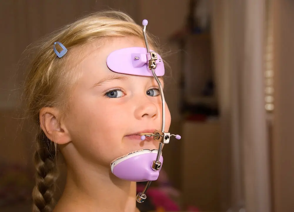 A beach scene with gentle waves washing onto the shore at sunset. The sky is a mix of soft pinks and oranges, and a person is visible in the distance near the water. A beach scene with gentle waves washing onto the shore at sunset. The sky is a mix of soft pinks and oranges, and a person is visible in the distance near the water.