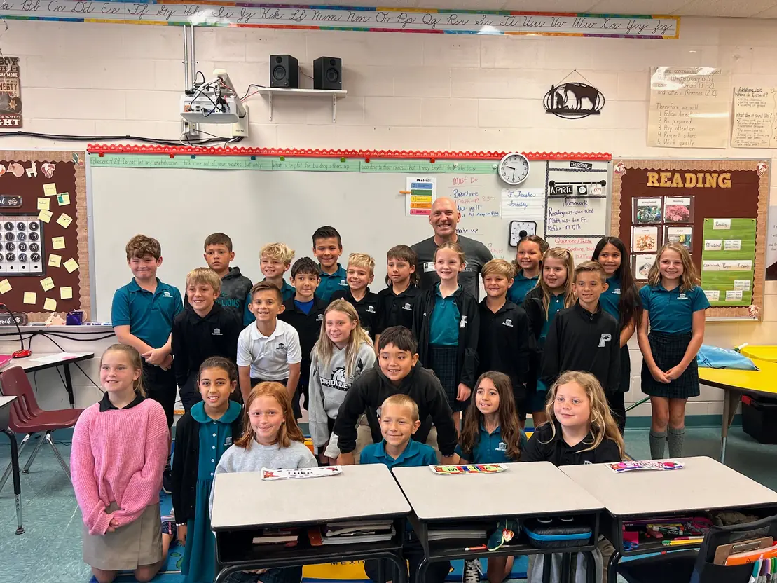 Dr. Marty Greenberg, orthodontist expert at Bold Bite Orthodontics in Jacksonville FL, poses with childrens and a teacher in a classroom, surrounded by desks and educational materials on the walls. Dr. Marty Greenberg, orthodontist expert at Bold Bite Orthodontics in Jacksonville FL, poses with childrens and a teacher in a classroom, surrounded by desks and educational materials on the walls.